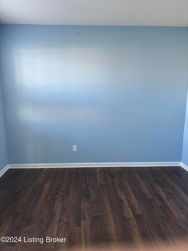 spare room featuring dark hardwood / wood-style floors