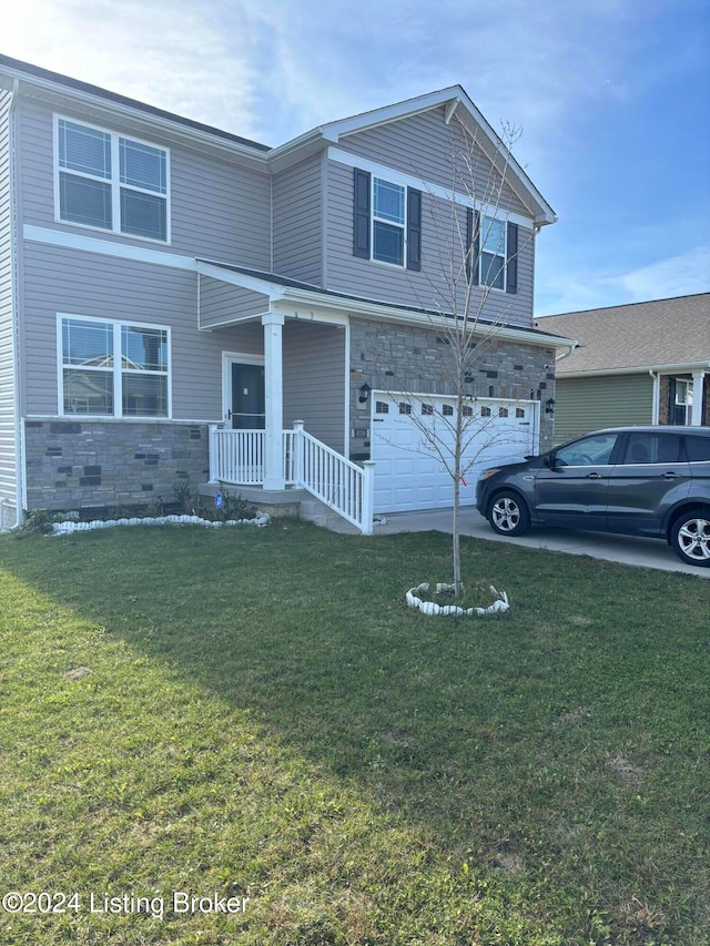 view of property with a front yard and a garage