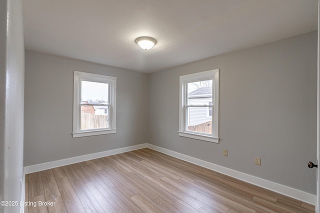 unfurnished room with light wood-type flooring