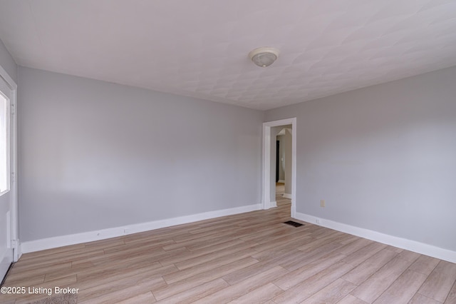 unfurnished room with light wood-type flooring