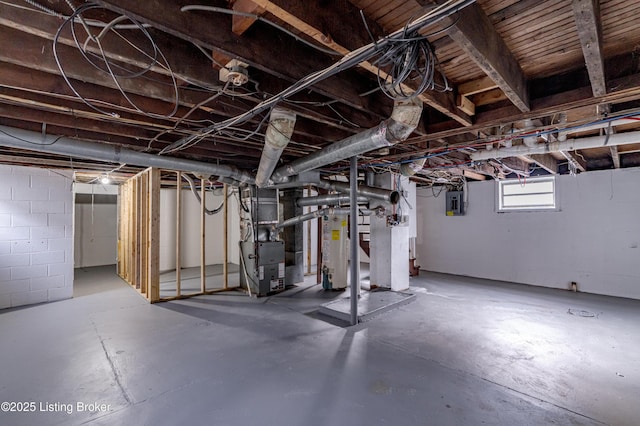 basement featuring heating unit and water heater