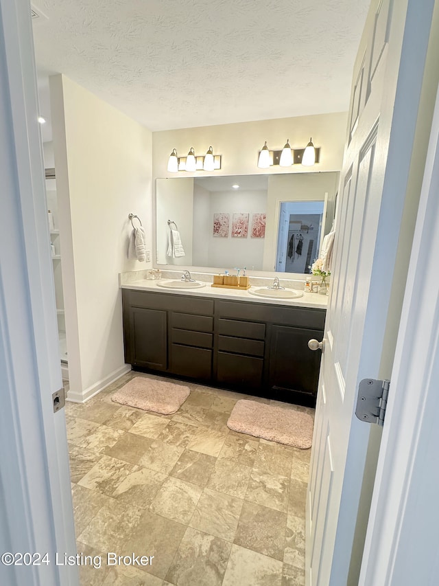 bathroom featuring vanity and a textured ceiling