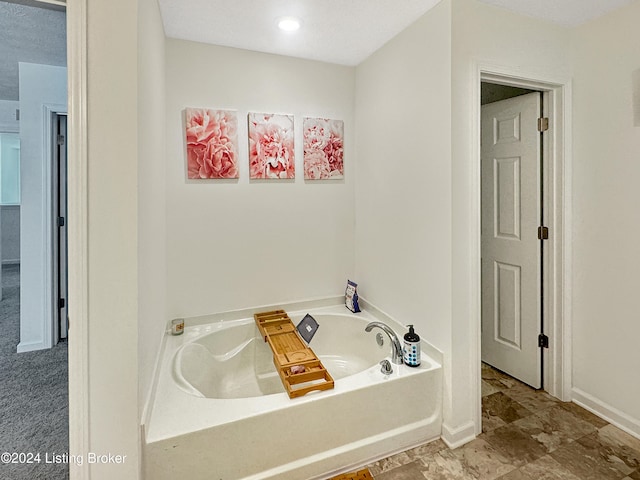 bathroom with a bathtub and a textured ceiling