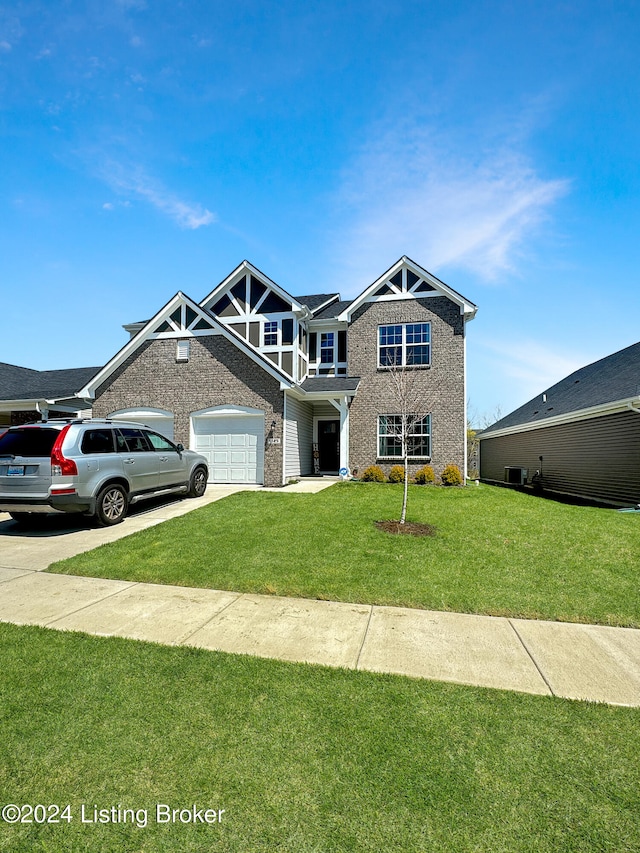 view of front of house with a front yard and a garage