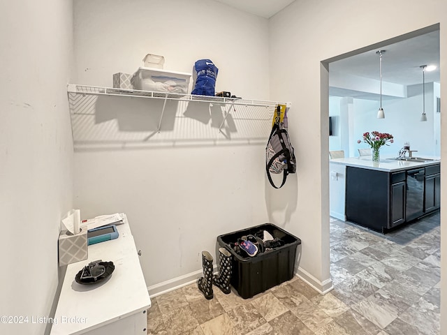 clothes washing area with sink