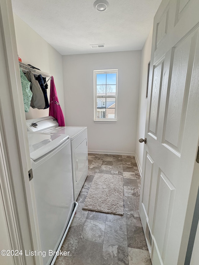 washroom featuring washer and clothes dryer