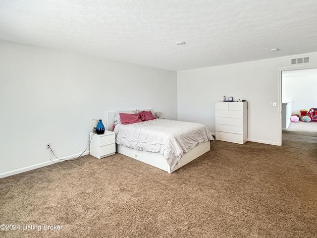 carpeted bedroom featuring a textured ceiling