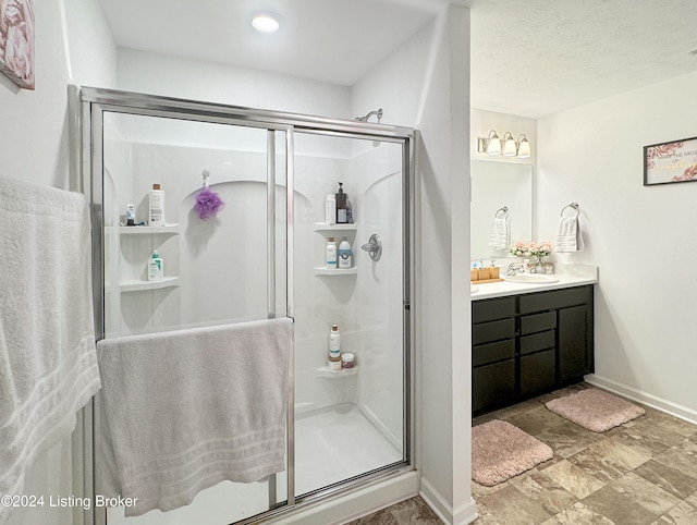 bathroom featuring vanity and an enclosed shower