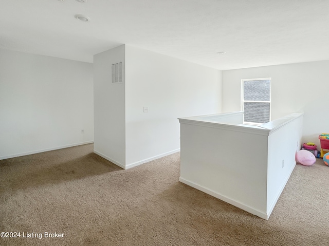 unfurnished room with light carpet