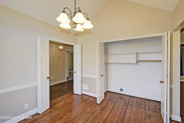 unfurnished bedroom featuring a closet, high vaulted ceiling, dark wood-type flooring, and an inviting chandelier