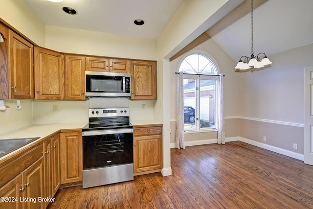 kitchen featuring pendant lighting, dark hardwood / wood-style flooring, stainless steel appliances, and a chandelier