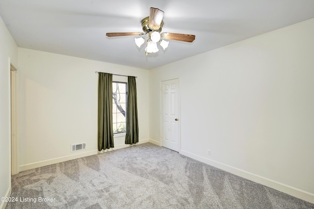 spare room with carpet and ceiling fan