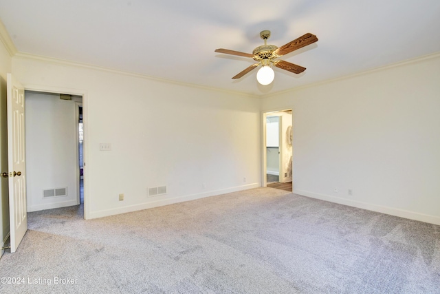 spare room with light carpet, crown molding, and ceiling fan