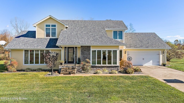 view of front of home with a front lawn and a garage