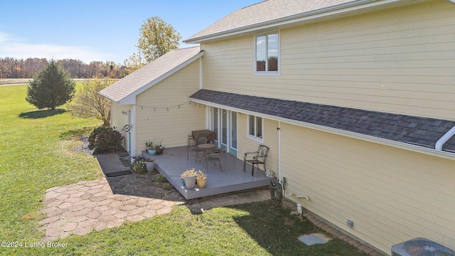 back of house featuring a yard and a patio area