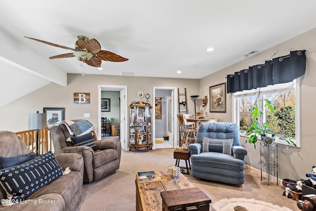 living room with lofted ceiling with beams, light colored carpet, and ceiling fan