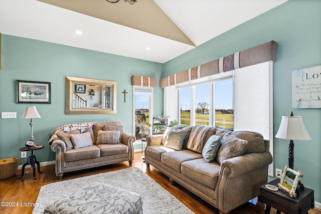 living room featuring dark wood-type flooring and lofted ceiling