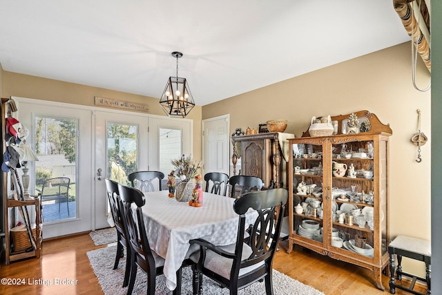 dining room with a notable chandelier and light wood-type flooring