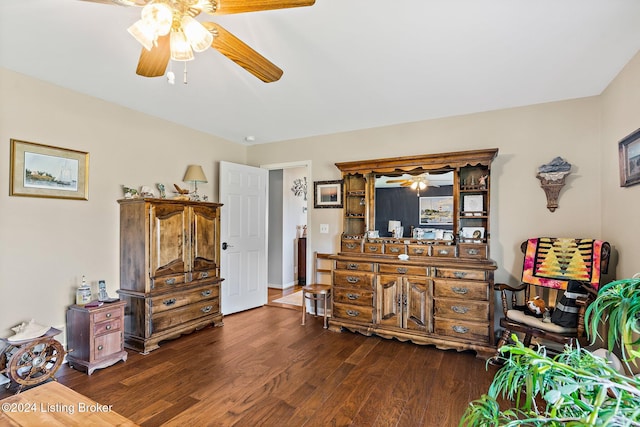 sitting room with dark hardwood / wood-style flooring and ceiling fan