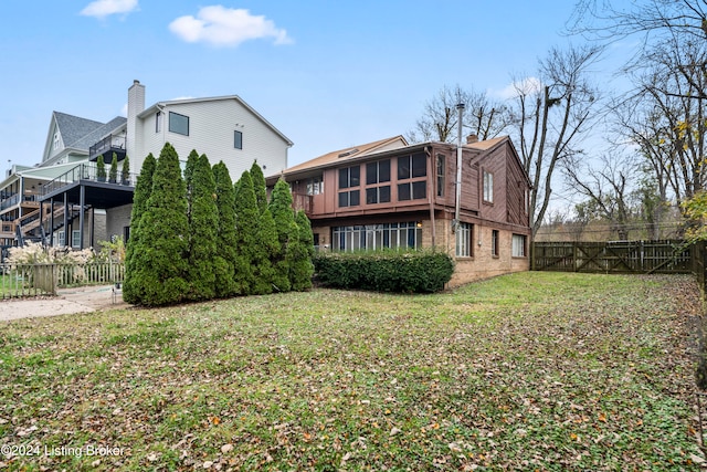 back of house featuring a yard