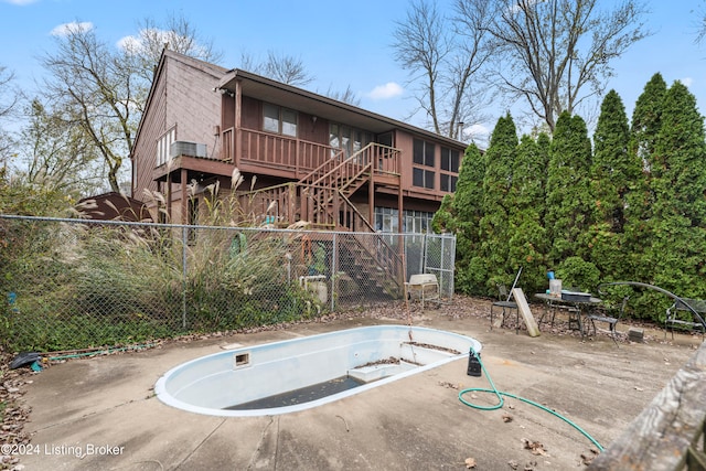 back of house featuring a patio and an empty pool