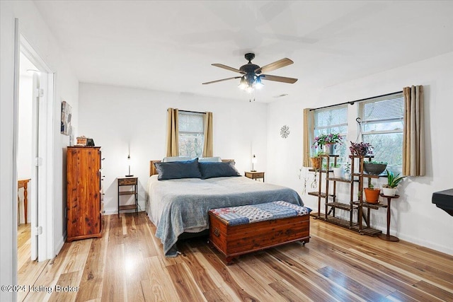 bedroom with light wood-type flooring and ceiling fan