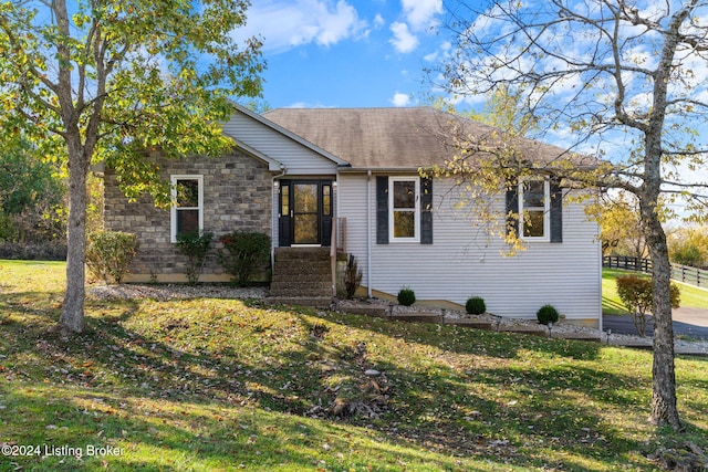 ranch-style home featuring a front yard