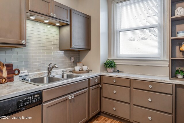 kitchen featuring dishwasher, a healthy amount of sunlight, light hardwood / wood-style floors, and sink