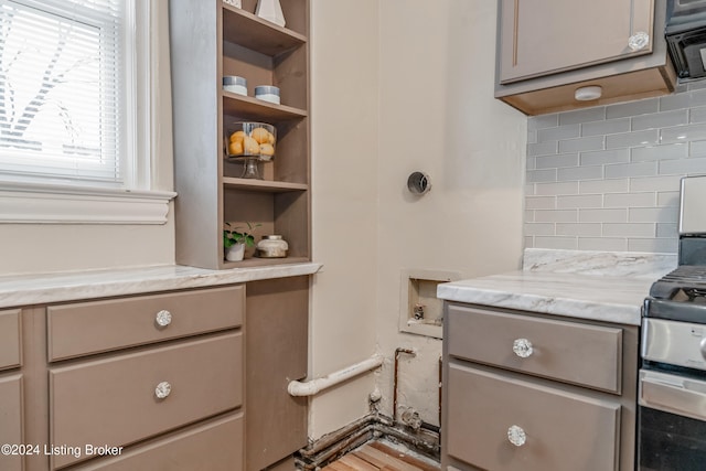 kitchen with light stone countertops and backsplash