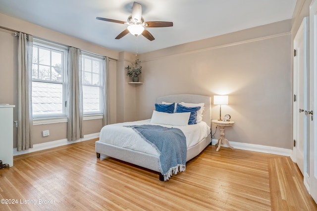 bedroom featuring hardwood / wood-style flooring and ceiling fan