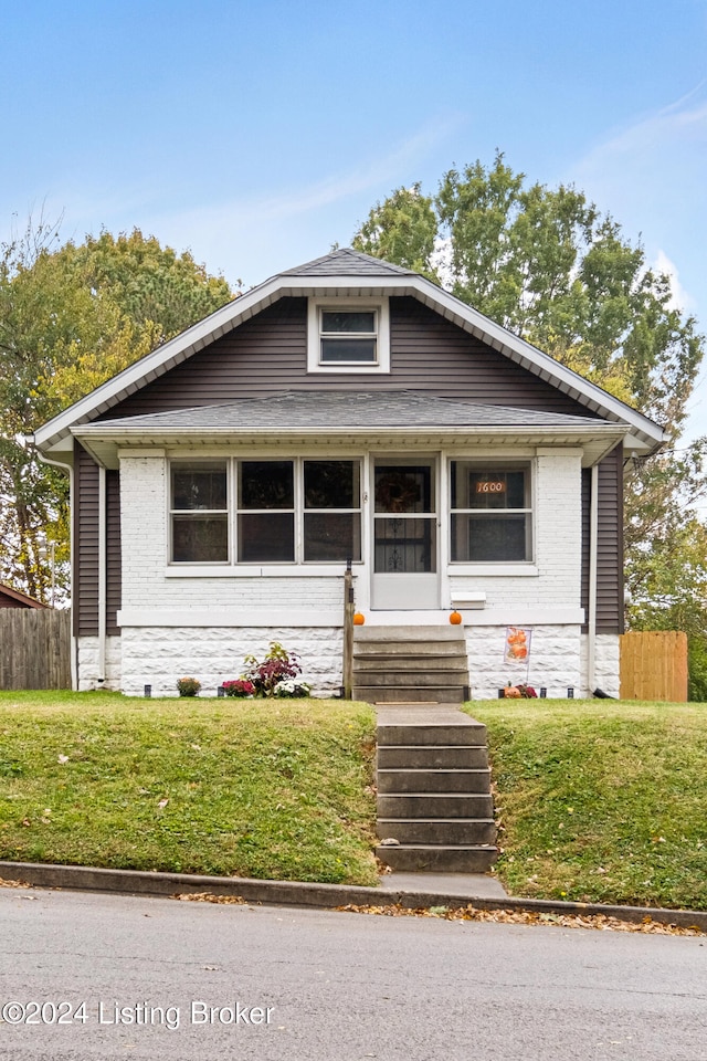 bungalow-style house with a front yard