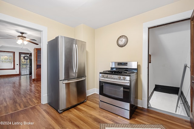 kitchen featuring appliances with stainless steel finishes, ceiling fan, and wood-type flooring