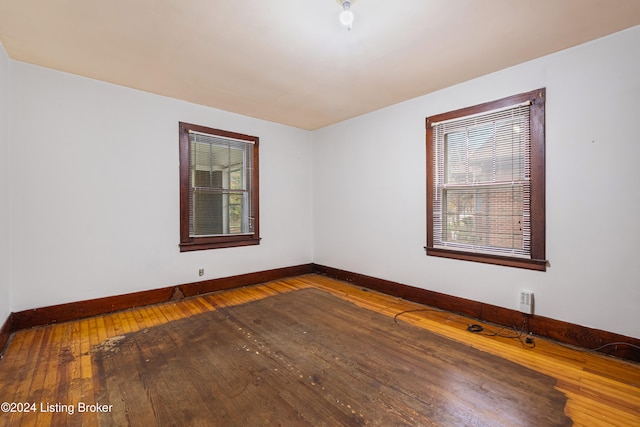 unfurnished room with wood-type flooring