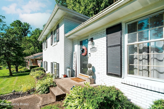 view of side of home with a yard