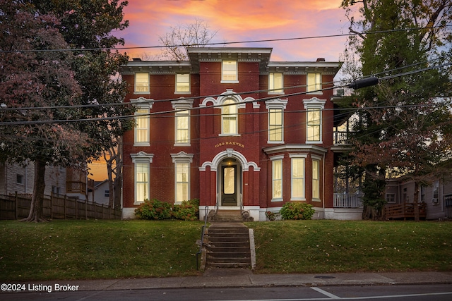 italianate home featuring a lawn