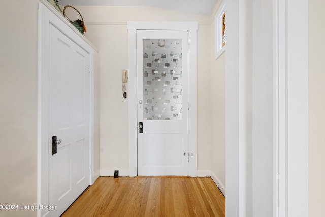 hall featuring hardwood / wood-style floors and lofted ceiling