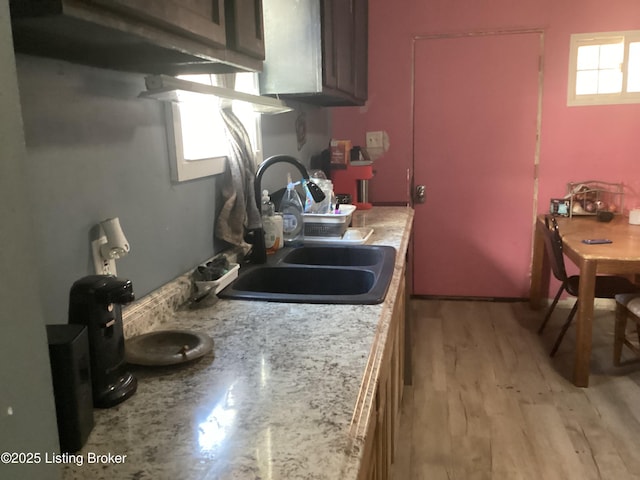 kitchen with sink and light hardwood / wood-style flooring