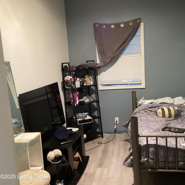 bedroom with wood finished floors