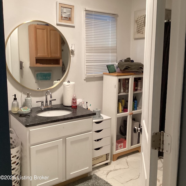 bathroom with marble finish floor and vanity