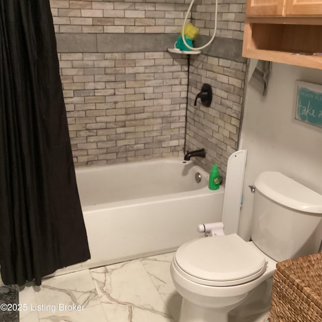 full bathroom with shower / bath combo with shower curtain, marble finish floor, and toilet