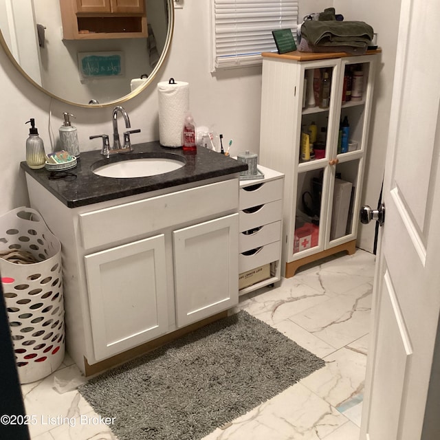 bathroom featuring vanity and marble finish floor