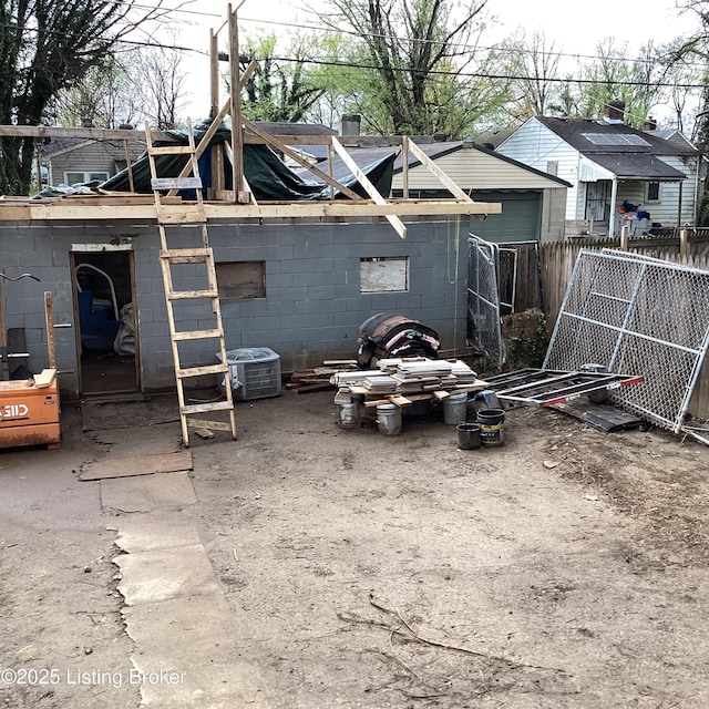 exterior space with fence and central AC