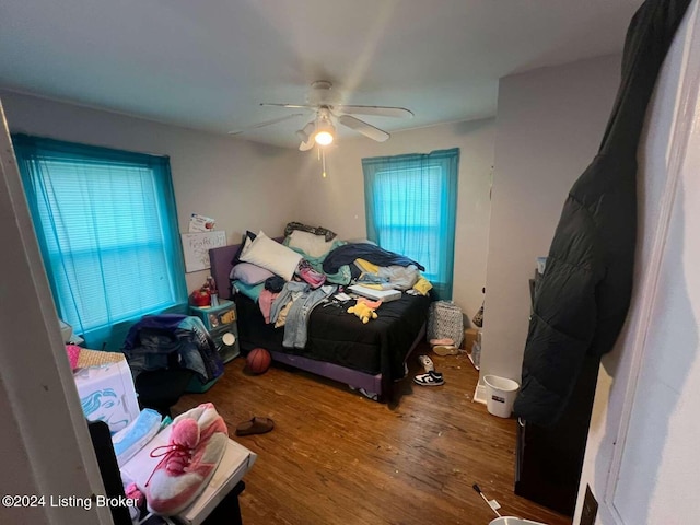 bedroom with hardwood / wood-style flooring and ceiling fan