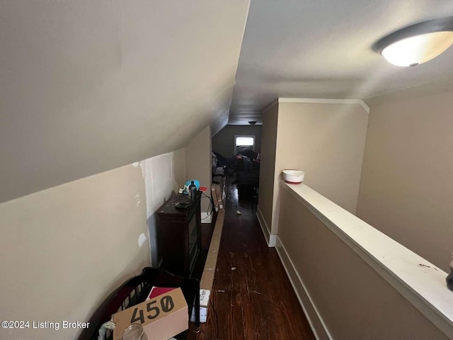 hallway featuring dark wood-type flooring and lofted ceiling