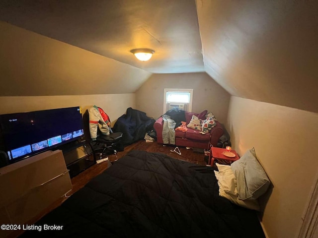 bedroom with vaulted ceiling and hardwood / wood-style flooring