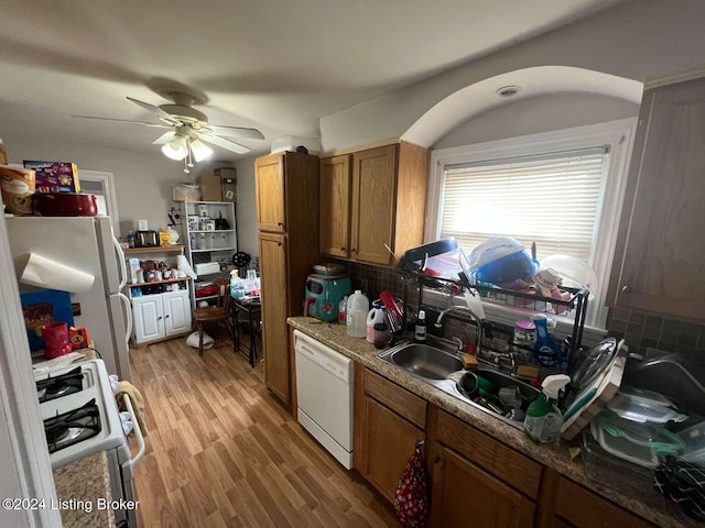 kitchen with decorative backsplash, ceiling fan, white appliances, and light hardwood / wood-style flooring