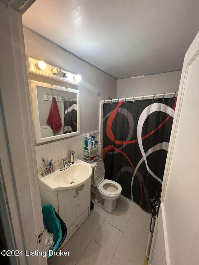 bathroom with tile patterned flooring, vanity, toilet, and a shower with shower curtain