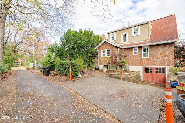 rear view of house featuring a garage