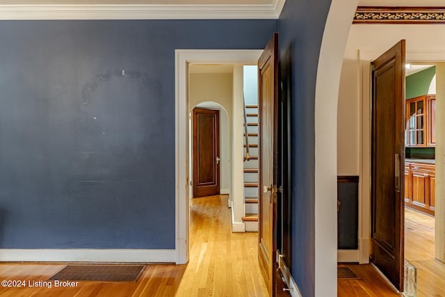 hallway featuring light hardwood / wood-style flooring and ornamental molding