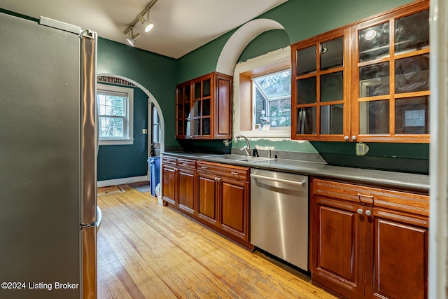 kitchen featuring sink, stainless steel appliances, plenty of natural light, and light hardwood / wood-style floors